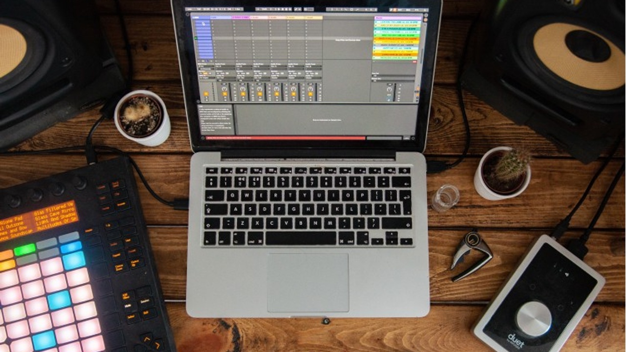 MacBook Pro music production setup running Logic Pro with an Apogee audio interface. Ideal professional gear for creating high-quality hip hop beats for sale on BuyBeatsNow.com.