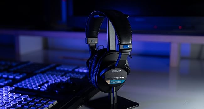 Sony MDR-7506 closed-back professional studio monitor headphones on a keyboard, ideal for tracking and monitoring beats.